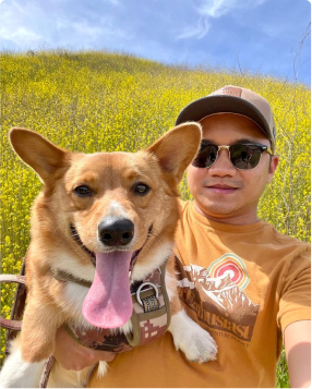 Aya clinician with dog in field of flowers